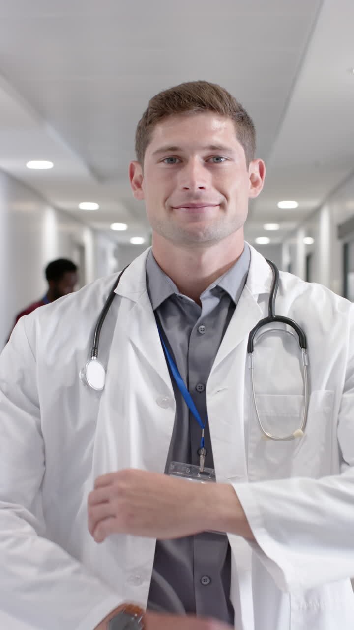 A physician standing in a bright hospital corridor